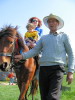 Ekin rides the horse with mom.